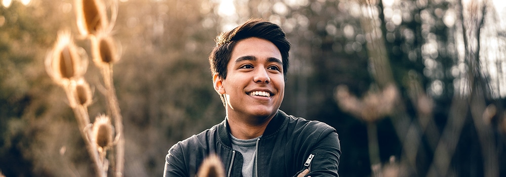 man smiling outdoors.